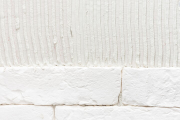 The process of laying decorative tiles on a wall in an apartment of a residential building. Close-up of ceramic tiles with glue on the wall.