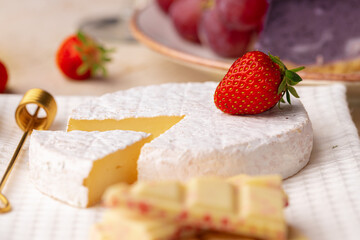 Soft cheese, strawberry and white chocolate close up