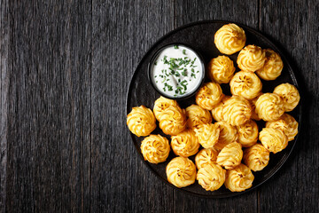 Duchess potatoes served on a black plate