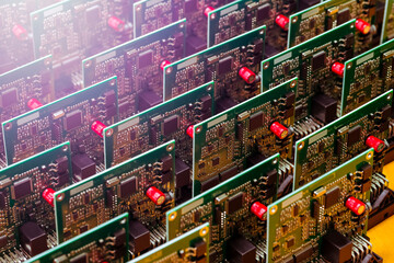 Close-up Image of Produced Automotive Printed Circuit Boards with Soldered Surface Mounted Components With Light Flares.