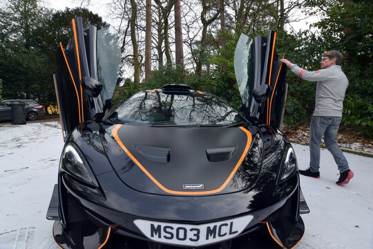 Glynn displays his most recently acquired McLaren at his home in Headley Down