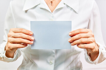 Business woman holding empty blue card on white background