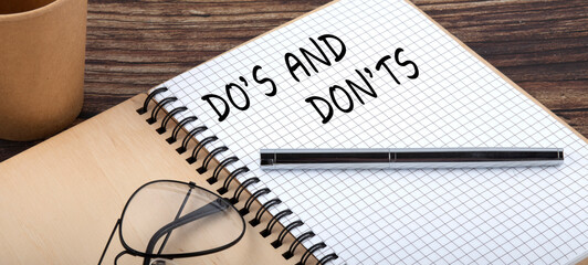 Do's and Don'ts words written in an office notebook. Concept in business.