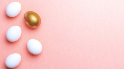 Easter message. Golden, white colour egg on pastel pink background in Happy Easter decoration. Foil minimalist egg design, modern top view template.