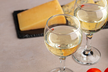 Different types of cheese and wine on gray table