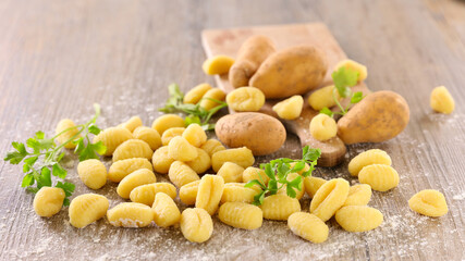 raw gnocchi on wood background