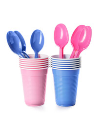 Plastic spoons and cups on white background