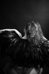 girl in feathers,  beautiful cape made of raven feathers on a slender female body, black and white...