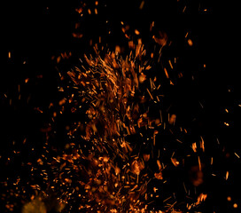 Fototapeta na wymiar sparks of fire on black background