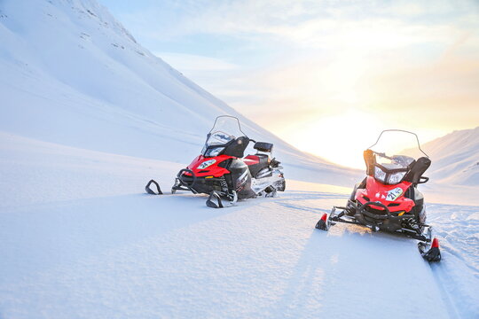 Kirovsk, Russia - FEBRUARY 1, 2021 red snowmobiles brp lynx adventure lx 600 on a background of snowy mountains on a sunny day. 