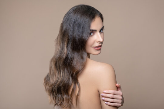 Young Woman With Bare Shoulder Looking Back