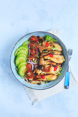 Salad bowl with roaster king oyster mushrooms, tomato, cucumber and red onion