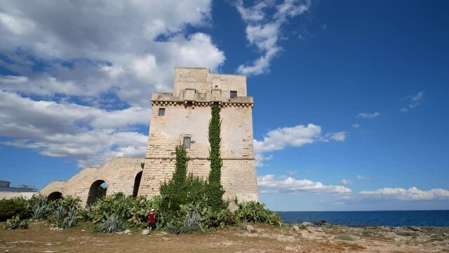 Picturesque historical fortification tower Torre Colimena on Salento Ionian sea coast, Taranto, Puglia, Italy
