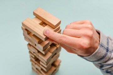 Planning, risk and strategy in business, wooden block tower
