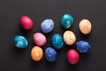 Fototapeta na wymiar Easter eggs on dark stone background, top view