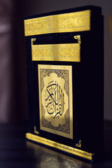Holy Quran Book  black and golden color. Arabic calligraphy.  Symbol of Islam. 