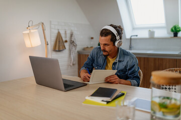 There's so many ways to stay connected. Male is using laptop at home