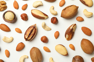 Different tasty nuts on whole background, close up