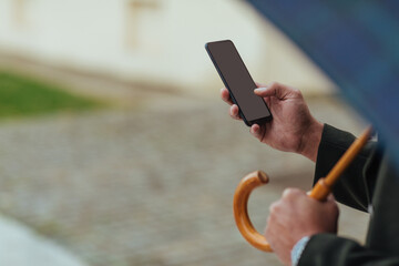 Close up of man using phone while out in the city