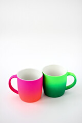 two colored cups in the studio on a white background