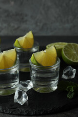 Tray with shots of vodka, lime, mint and ice