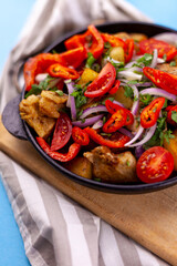 Pork ojakhuri with vegetables. Meat, potatoes, onions, herbs, peppers cooked and served in a skillet. A dish of Georgian cuisine. Meat food, lunch, dinner on the table.