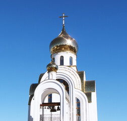 Orthodox church with gilded domes. Blue sky.     