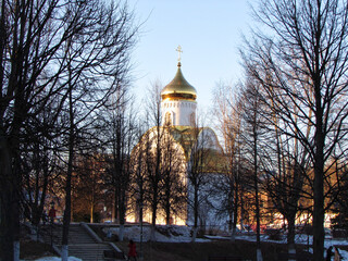Orthodox church with a gilded dome in the middle of the park. 