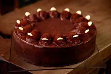 Chocolate cake above with fresh cocoa on wooden table