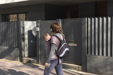 a woman carrying her child exercising in an urban environment