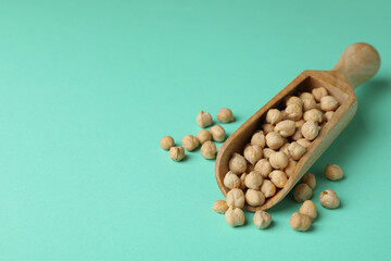 Scoop with fresh chickpea on mint background