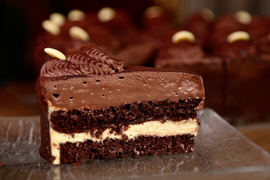 Piece Of Chocolate Cake Above With Fresh Cocoa On Wooden Table