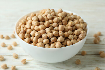 Bowl with chickpea on white wooden table