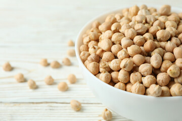Bowl with chickpea on white wooden table