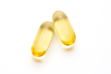 Dietary supplement oil capsules on a white background, softgel capsules.
