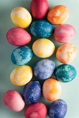 Easter eggs on blue background, top view