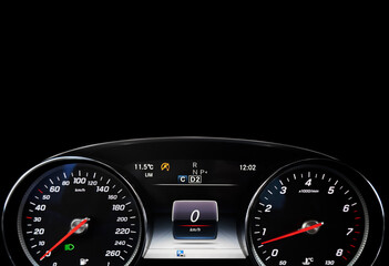Fototapeta premium Close up shot of a tachometer in a car. Car dashboard. Dashboard details with indication lamps. Car instrument panel. Dashboard with speedometer, tachometer, odometer. Car inside