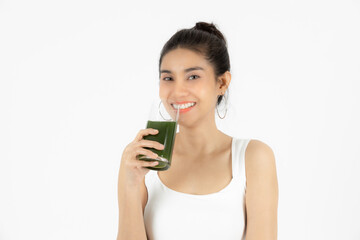 Beautiful young Asian woman drinking green detox vegetable smoothie over white isolated background. Fitness and health care concept, Vegetarian drink juice, Healthy lifestyle.