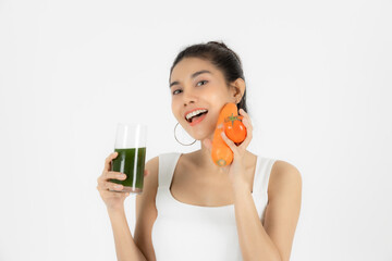Beautiful young Asian woman drinking green detox vegetable smoothie over white isolated background. Fitness and health care concept, Vegetarian drink juice, Healthy lifestyle.