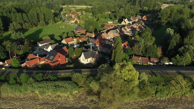 Vlassenbroek, Belgium - June 1 2019: Aerial view of Vlassenbroek, a picturesque village on the shore of Scheldt river, in East Flanders
