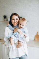 Happy mother and infant daughter playing together at home. Childhood, family concept