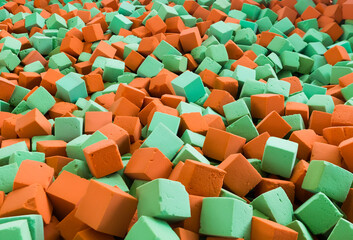 Background with bright red and green soft blocks or cubes. Multicolored geometric background.