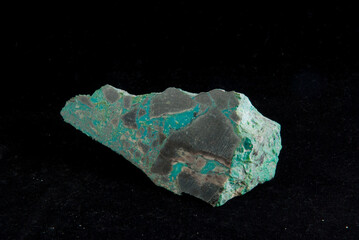 a  green malachite mineral sample on a black background - obrazy, fototapety, plakaty