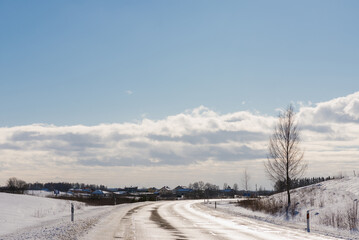 Fototapeta na wymiar Winter road under blue sky.Rural road asphalt.