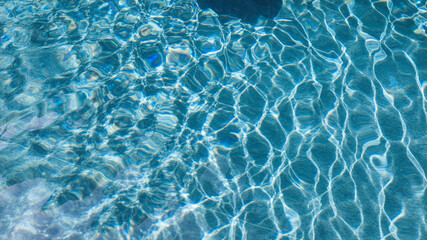 Abstract pool water.  Swimming pool bottom caustics ripple and flow with waves background surface of blue swimming pool