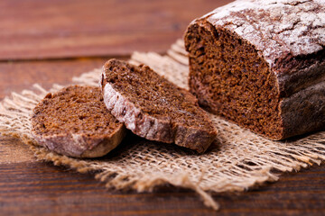 Loaf of rectangular rye bread on burlap