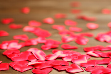 Cute red silk hearts on brown wooden planks table close up view, selective focus, copy space. Holidays, Womens day, Mothers day, love, romantic, rendezvous card, banner, flyer, invitation template