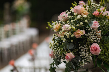 Wedding floral arrangement with pink roses, alchemilla and eucalyptus.