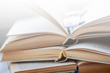 Open book on a window sill, illuminated by sunlight.