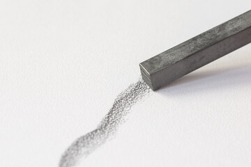 a bar of graphite draws a gray line